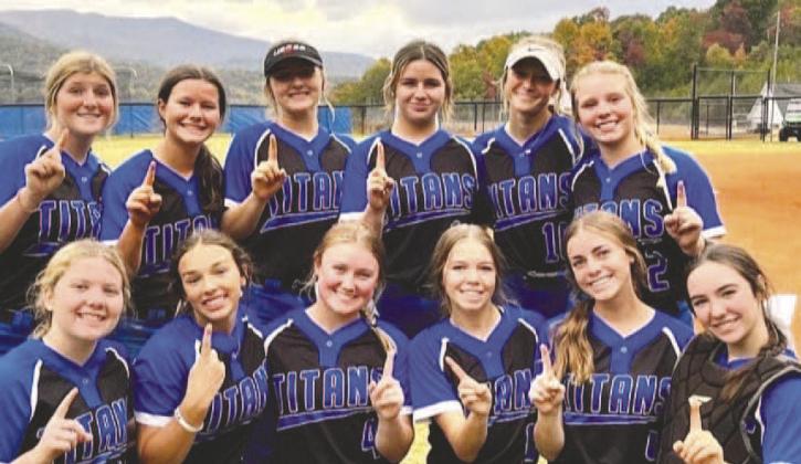 The Lady Titans’ softball team holds up ‘No. 1s’ after an away victory against Towns County to clinch the top spot in the region. CONTRIBUTED